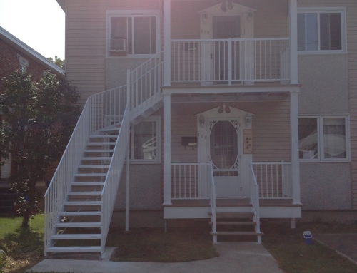 Front of a duplex with staicase, railing and columns2